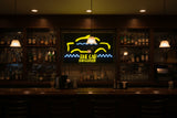 Neon sign for 'The Cab Bar & Grille' with yellow and blue design.